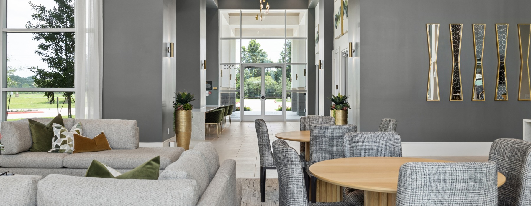 a room with chairs and tables overlooking the leasing office