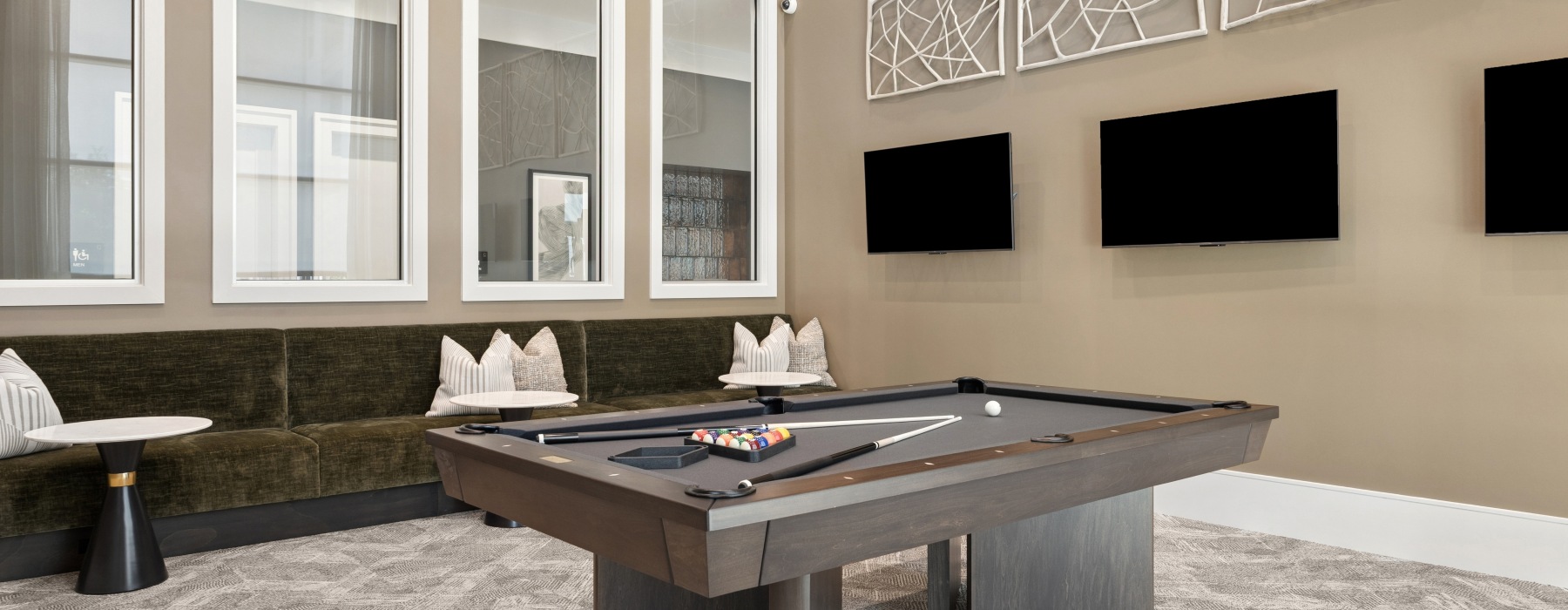 community space with pool table and couches