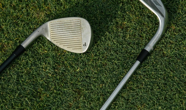 a pair of golf clubs on the grass