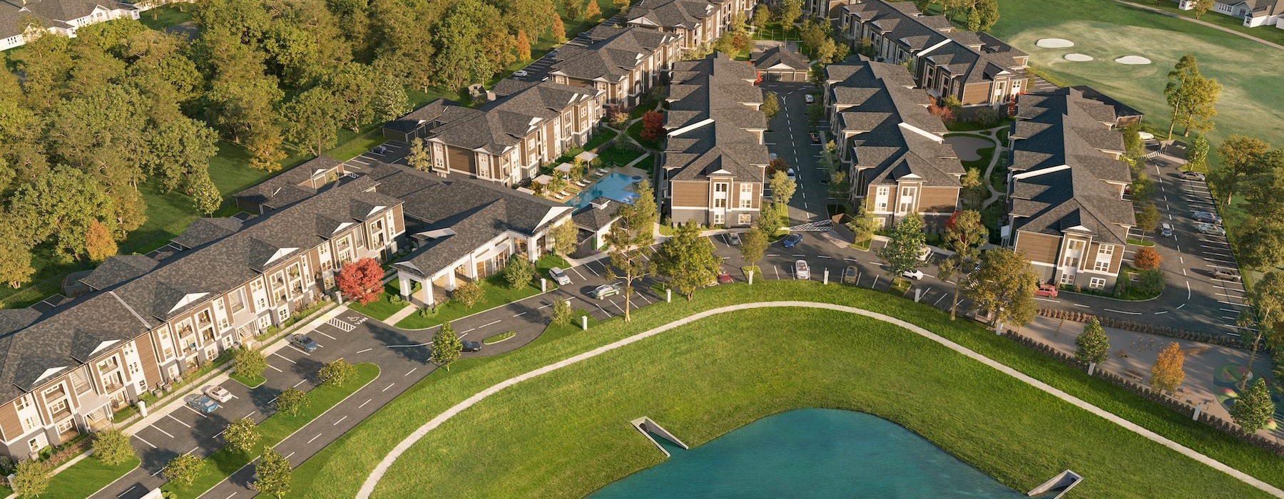an aerial view of a neighborhood with a pond