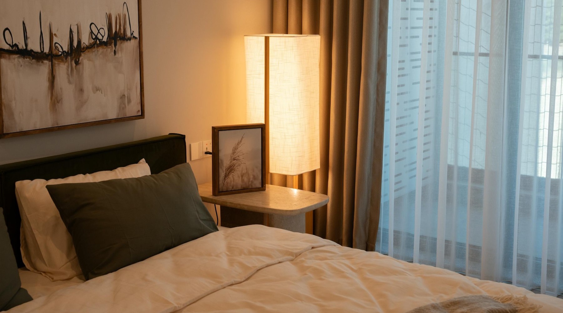 a bedroom with a bed and a lamp