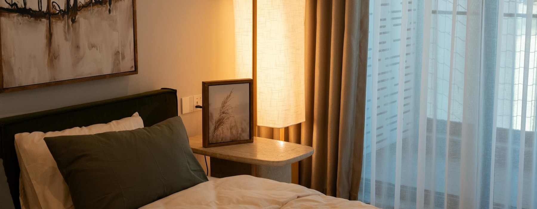 a bedroom with a bed and a lamp