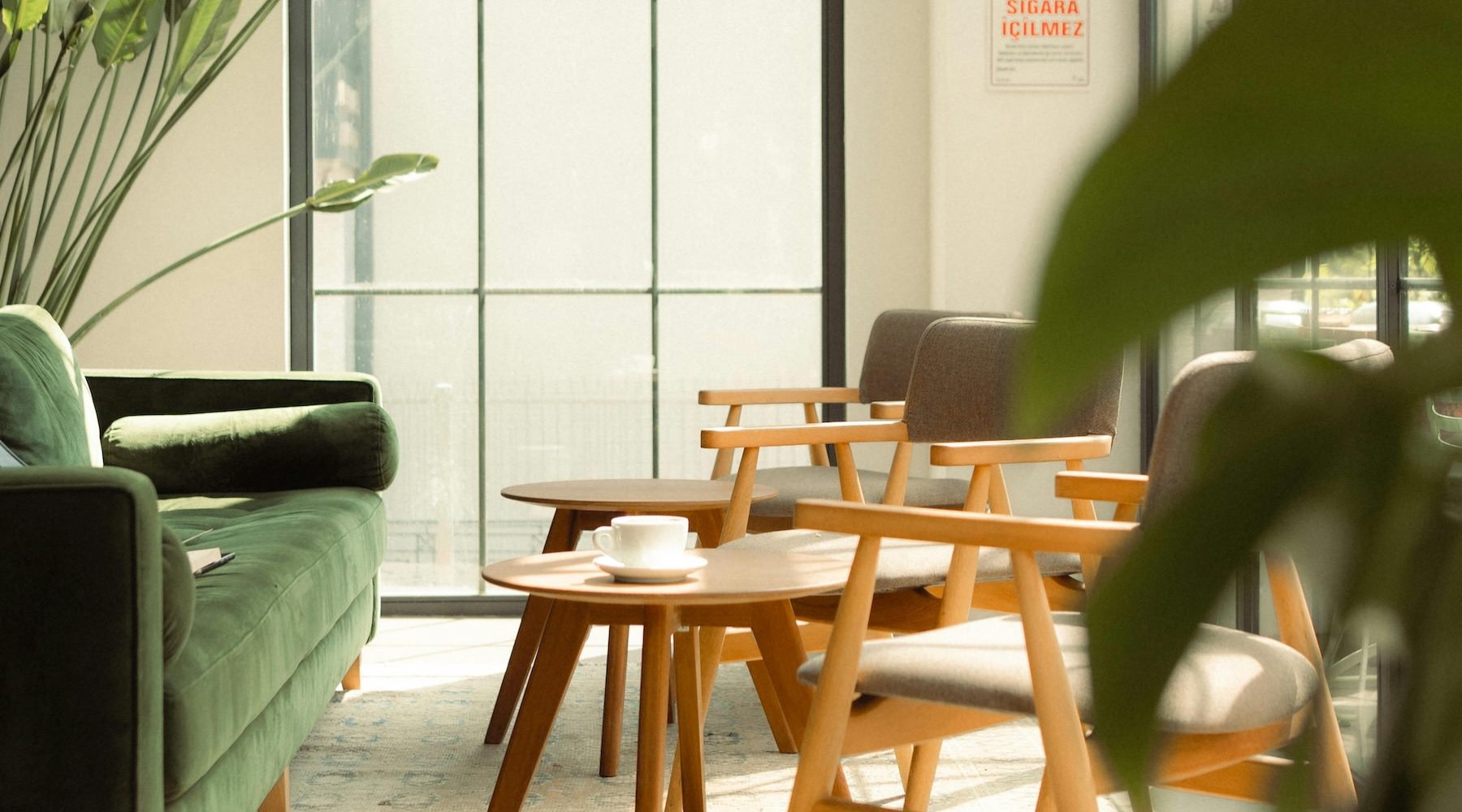 a room with a couch, tables and chairs